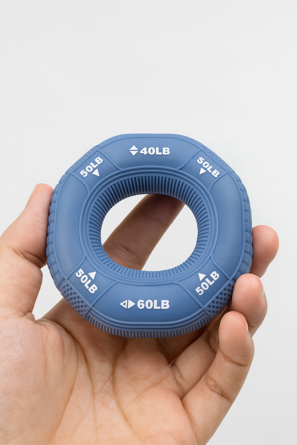 person using silicone grip strength ring for hand and forearm training